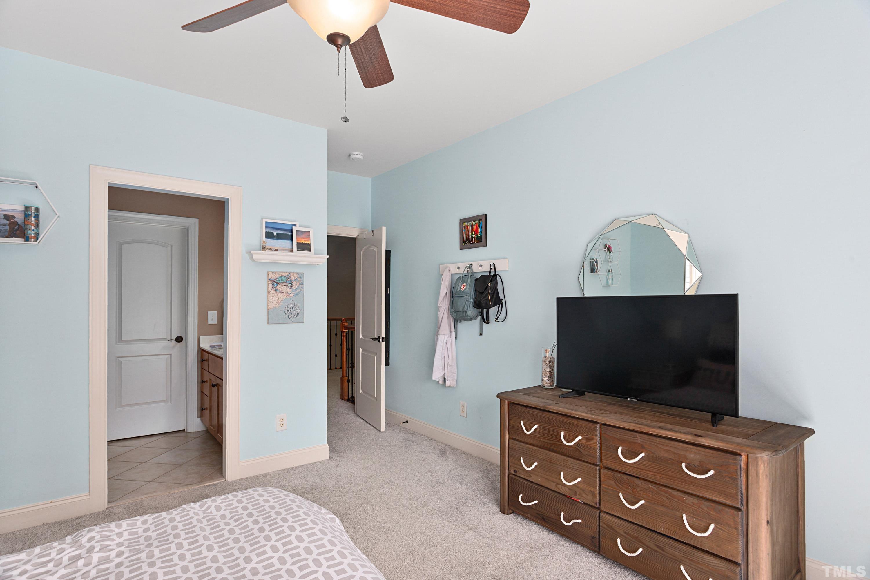 4328 Summer Brook Drive Apex, NC 27539 - Photo 42 of 76 a living room with furniture and a flat screen tv