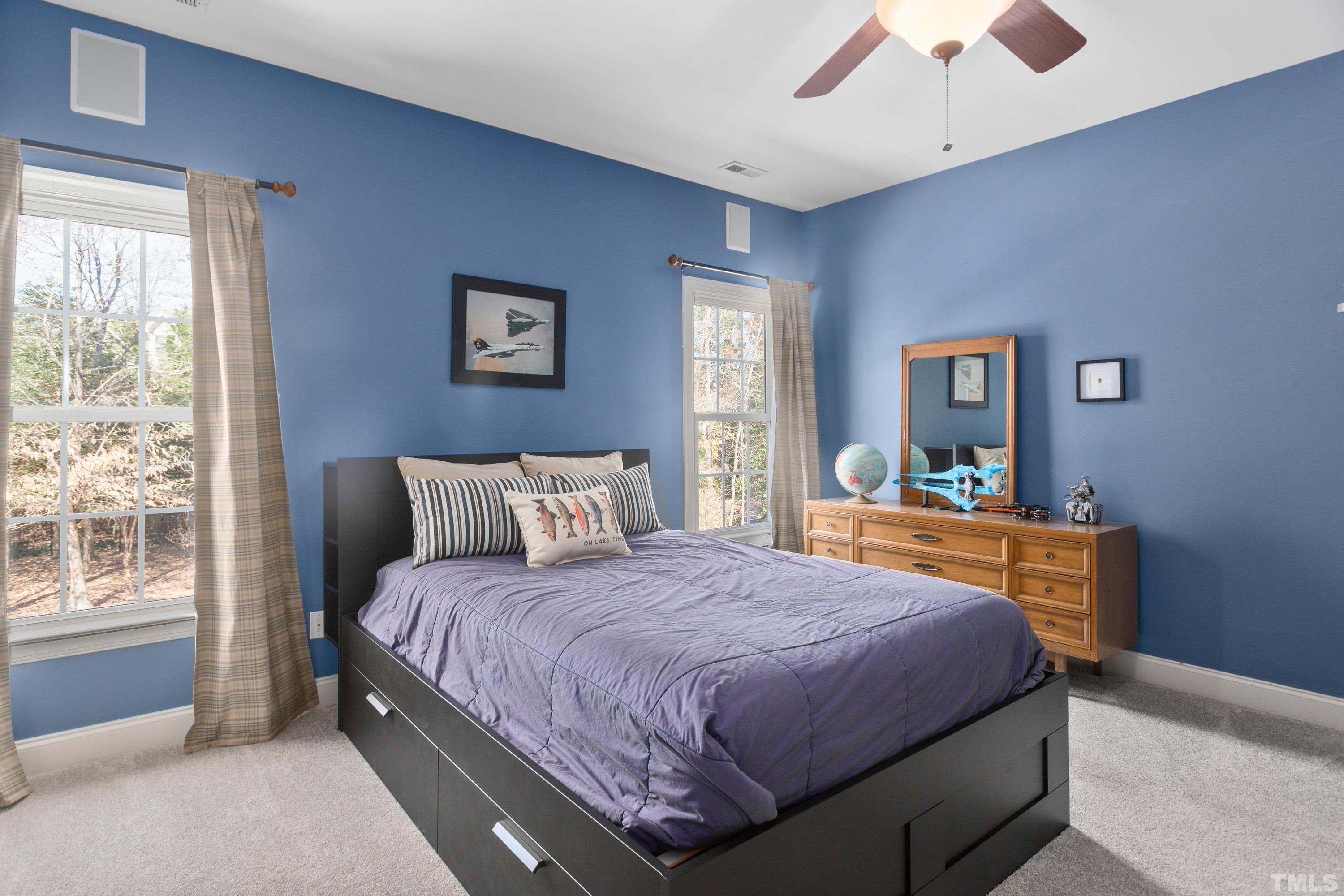4328 Summer Brook Drive Apex, NC 27539 - Photo 47 of 76 a bedroom with a bed and a dresser next to a window