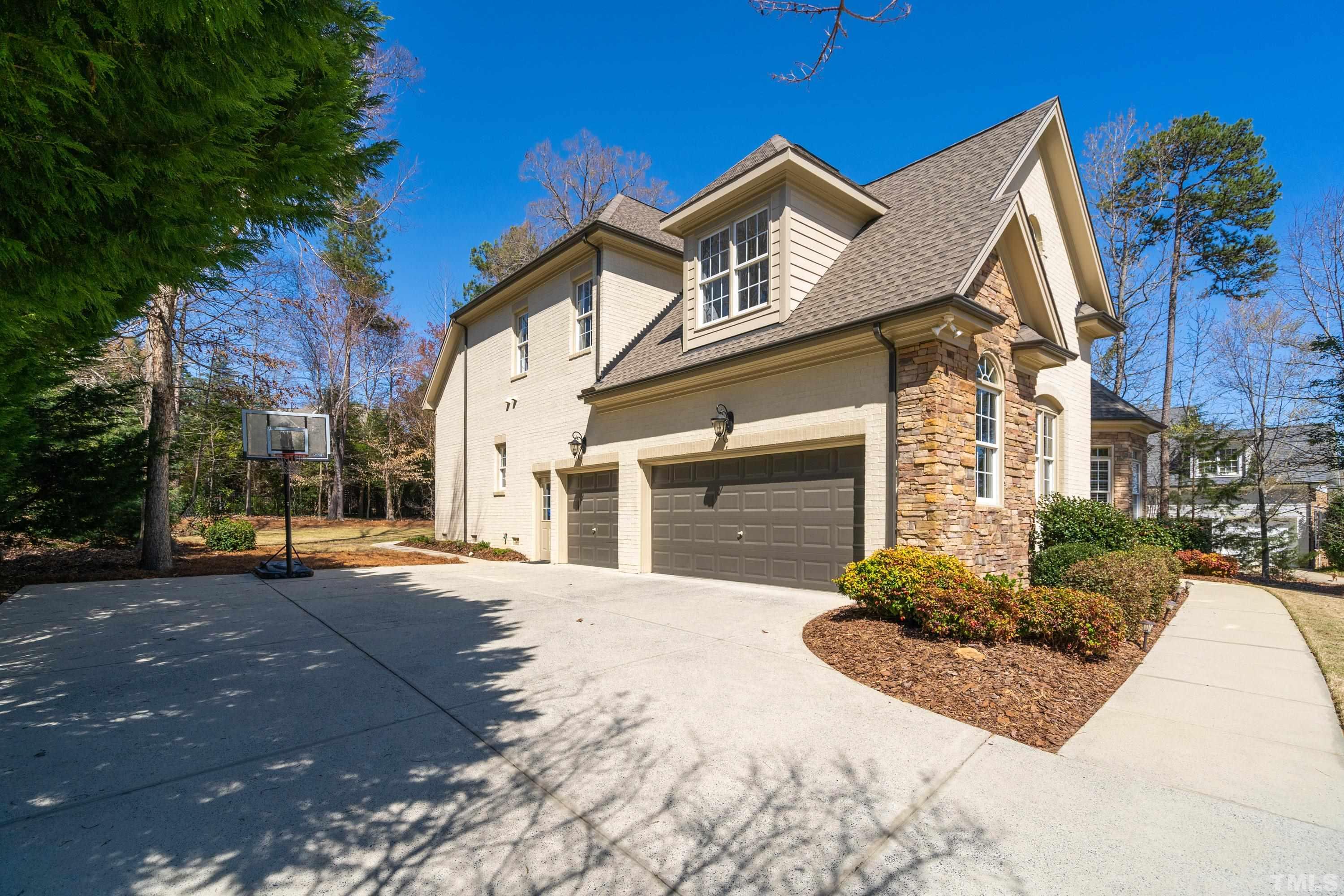 4328 Summer Brook Drive Apex, NC 27539 - Photo 69 of 76 a front view of a house with a yard and garage