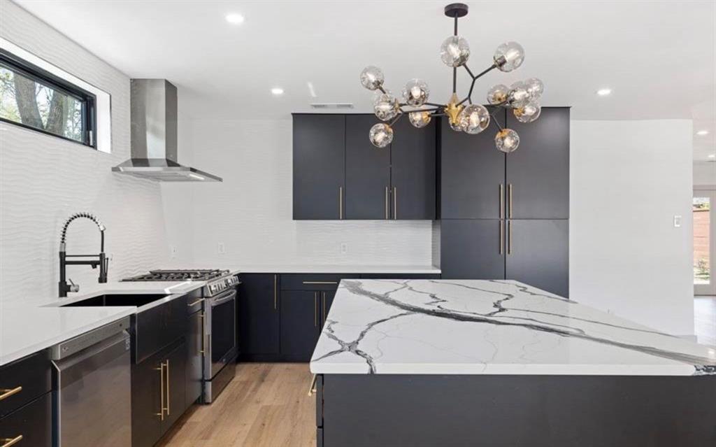 4927 Linnet Lane Dallas, TX 75209 - Photo 3 of 17 a kitchen with a sink and a refrigerator