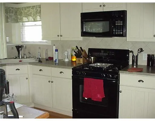 a kitchen with stainless steel appliances a stove and a microwave