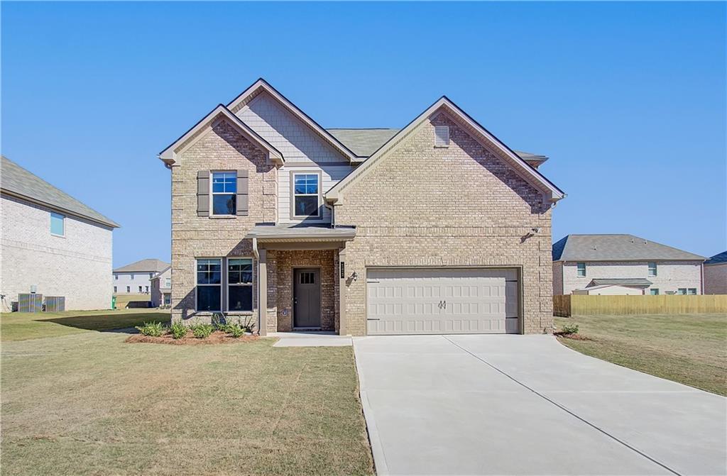a front view of a house with a yard and garage