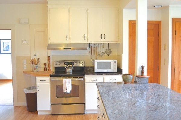 6 Davis Road Marblehead, MA 01945 - Photo 7 of 22 a kitchen with stainless steel appliances granite countertop a stove a sink and a white cabinets