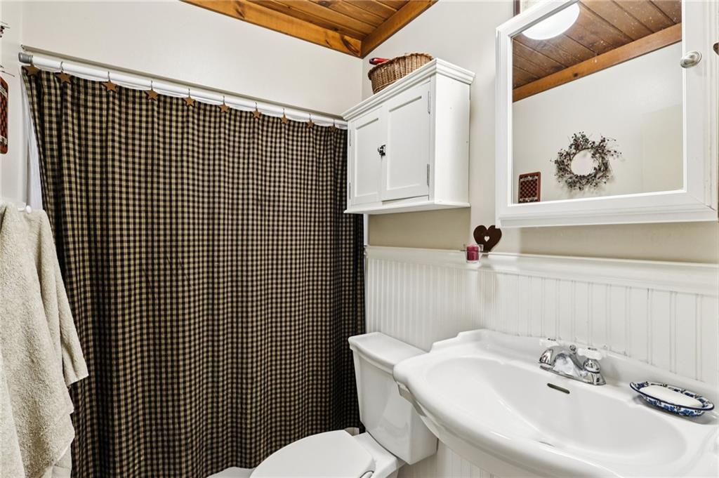 557 Wilson Mill Road New Wilmington, PA 16142 - Photo 27 of 41 a bathroom with a sink toilet and mirror