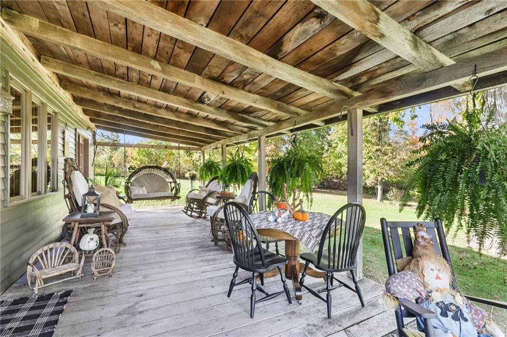 557 Wilson Mill Road New Wilmington, PA 16142 - Photo 8 of 41 a view of a patio with table and chairs and wooden floor