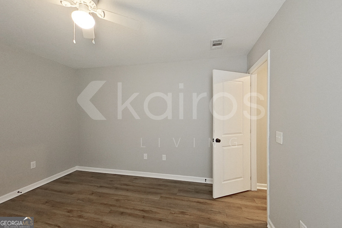 132 Cottage Grove Road Brunswick, GA 31525 - Photo 10 of 17 a view of an empty room with wooden floor and a window