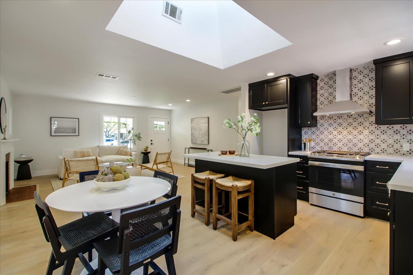 2229 Tulip Road San Jose, CA 95128 - Photo 14 of 34 a kitchen with stainless steel appliances granite countertop a stove a sink dishwasher a dining table and chairs with wooden floor