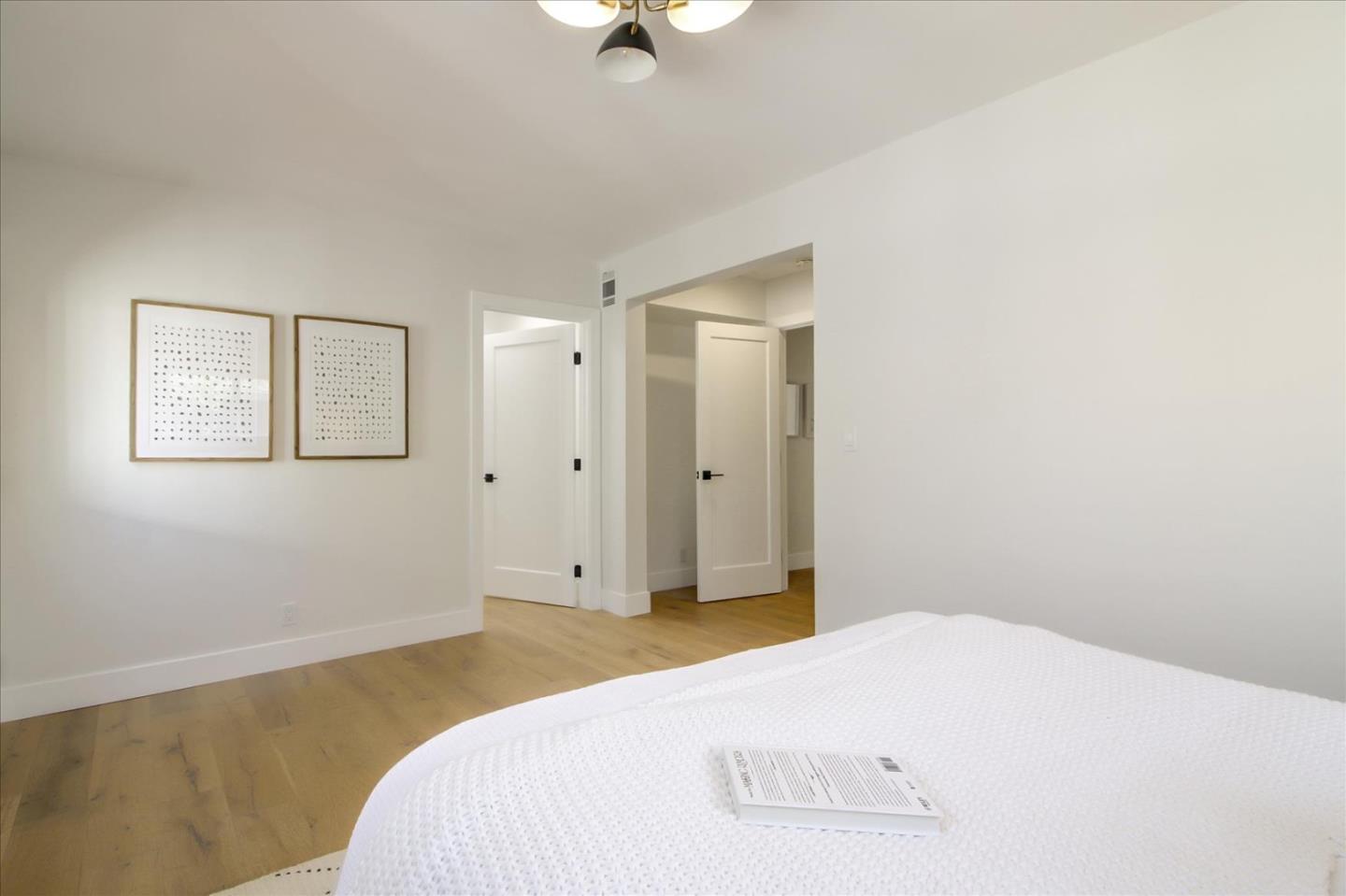 2229 Tulip Road San Jose, CA 95128 - Photo 24 of 34 a bedroom with a bed and a chandelier
