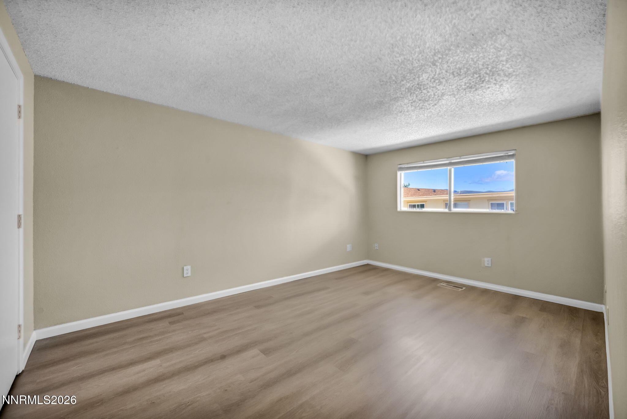 19 Condor Circle Carson City, NV 89701 - Photo 21 of 41 a view of an empty room with wooden floor and a window
