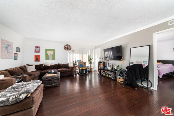 a living room with furniture window and wooden floor