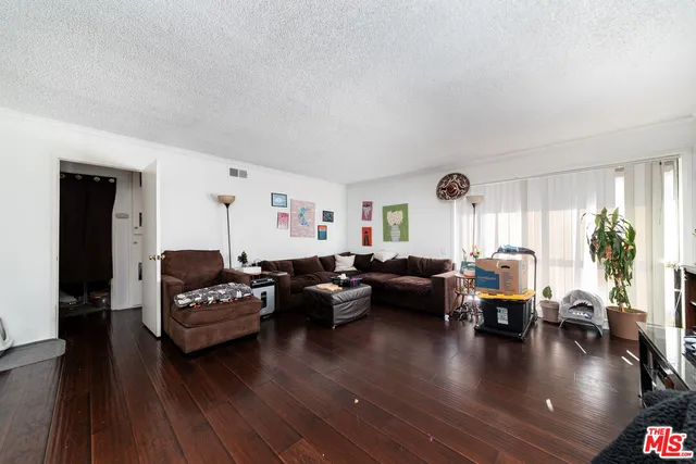 a living room with furniture window and wooden floor