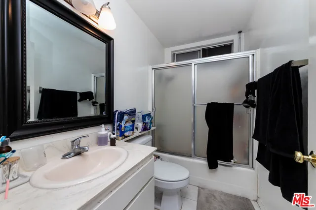 a bathroom with a sink toilet and mirror