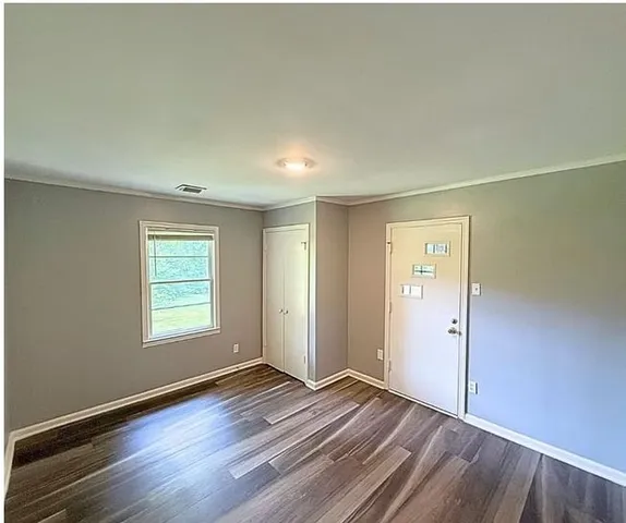 a view of a room with wooden floor