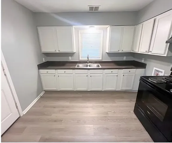 a kitchen with granite countertop a stove a sink and a granite counter tops