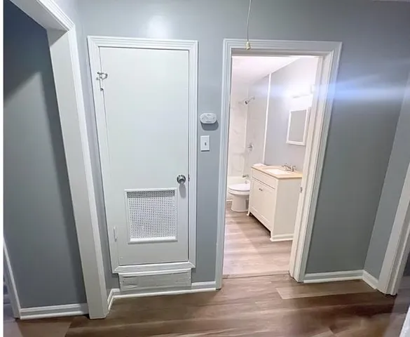 a view of a bathroom with a glass door and a sink