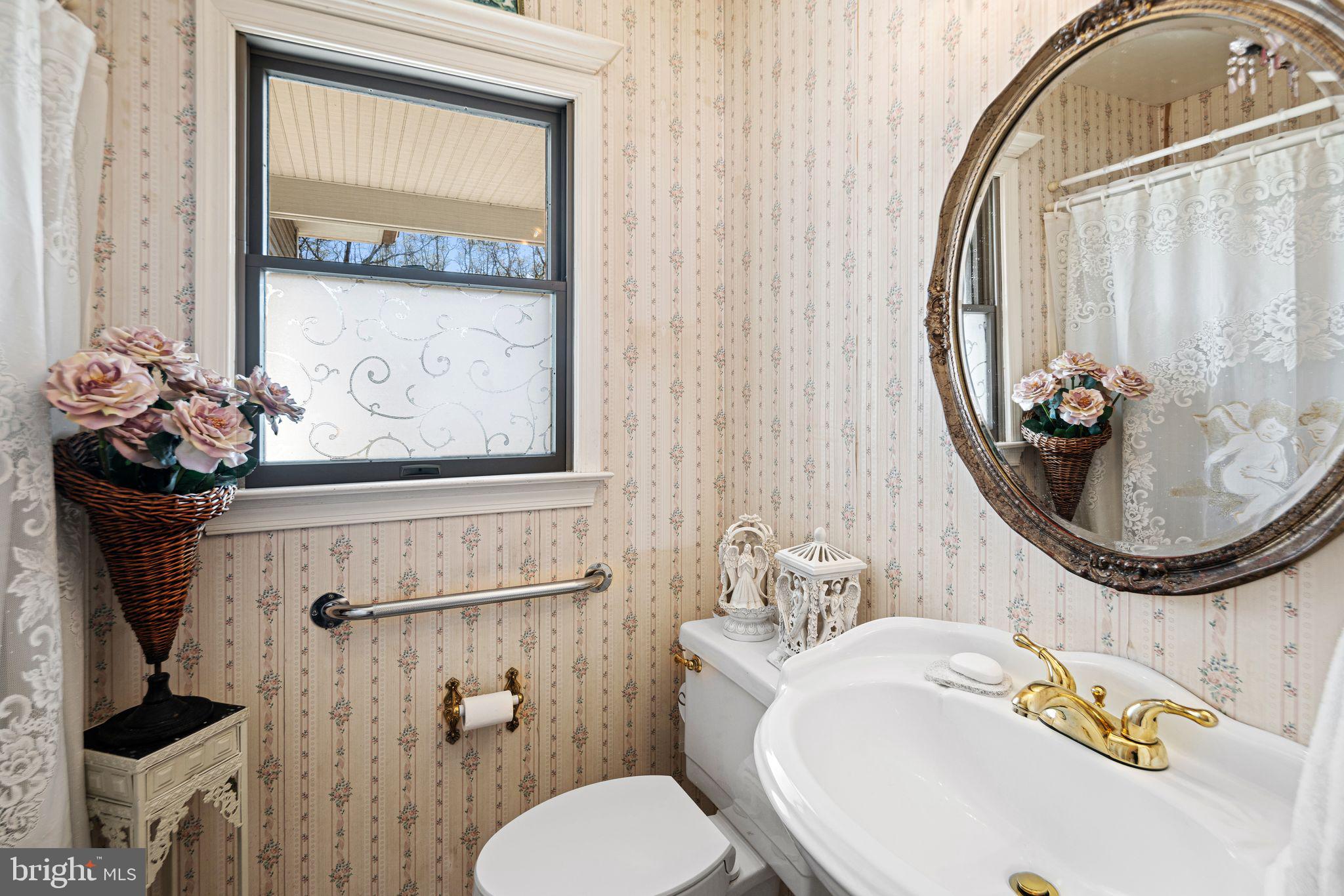 91 Estates Road Pine Hill, NJ 08021 - Photo 12 of 34 a bathroom with a toilet a sink and mirror