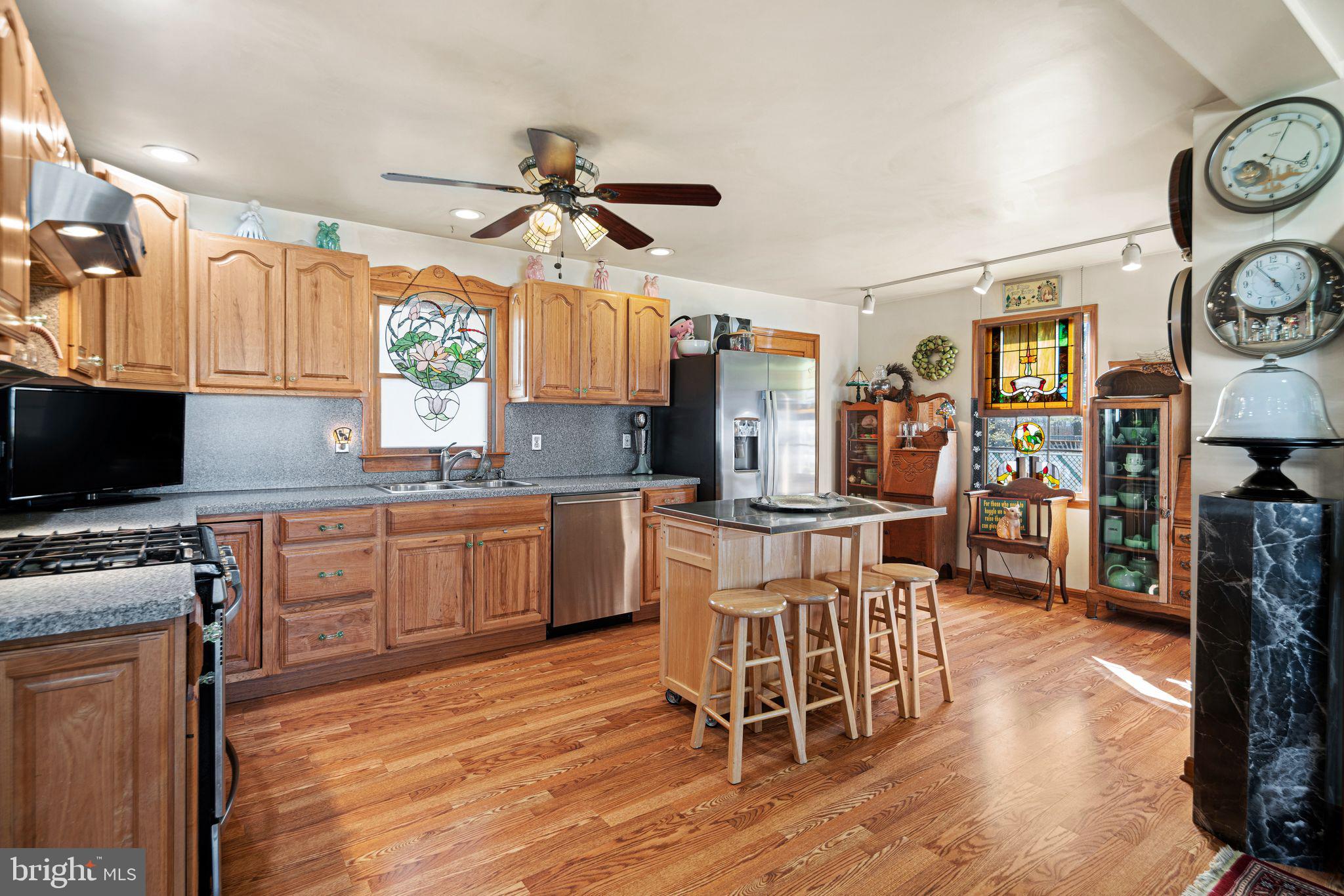 91 Estates Road Pine Hill, NJ 08021 - Photo 14 of 34 a kitchen with stainless steel appliances a stove a sink dishwasher and a refrigerator