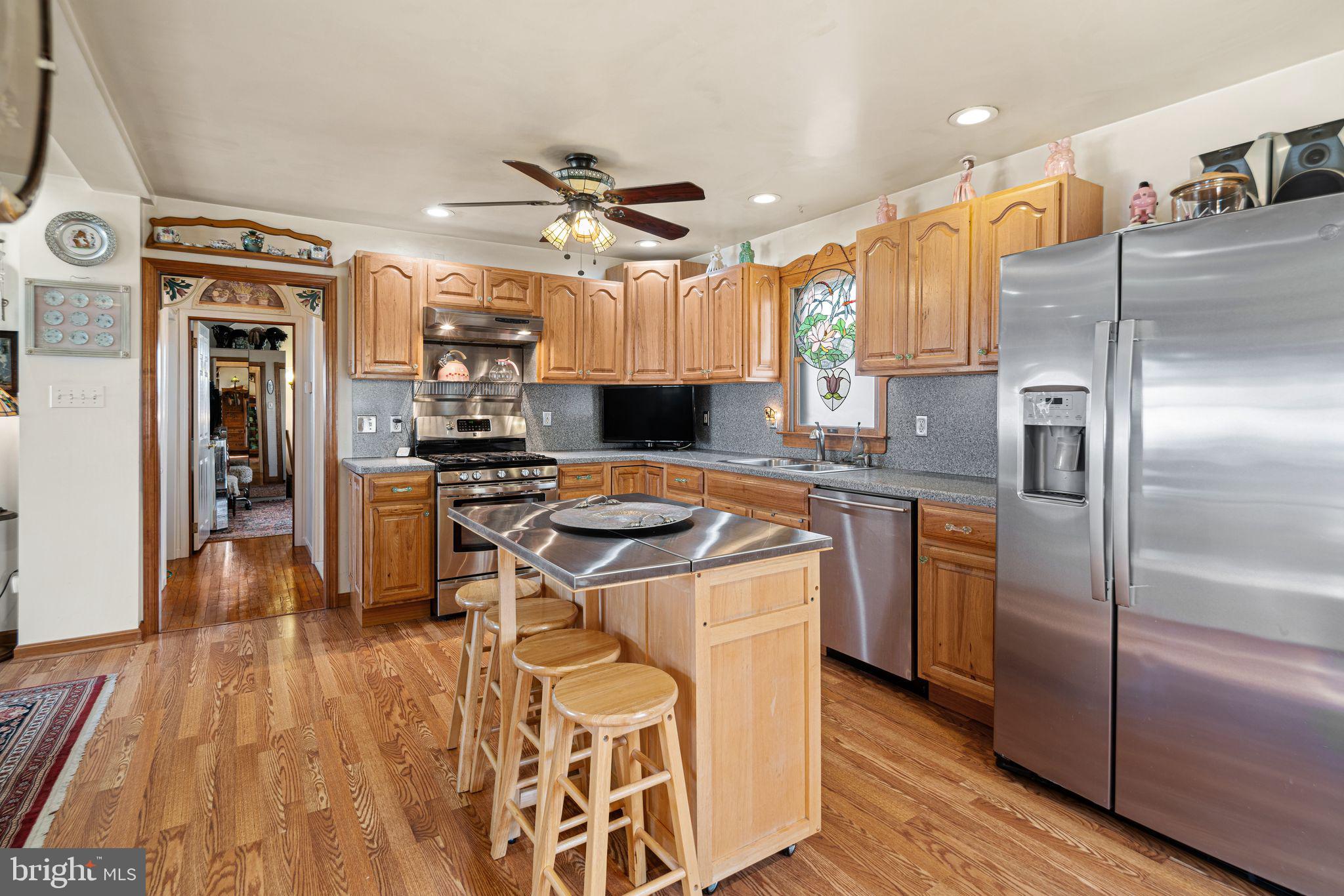 91 Estates Road Pine Hill, NJ 08021 - Photo 15 of 34 a kitchen with kitchen island a counter top space a sink appliances and cabinets