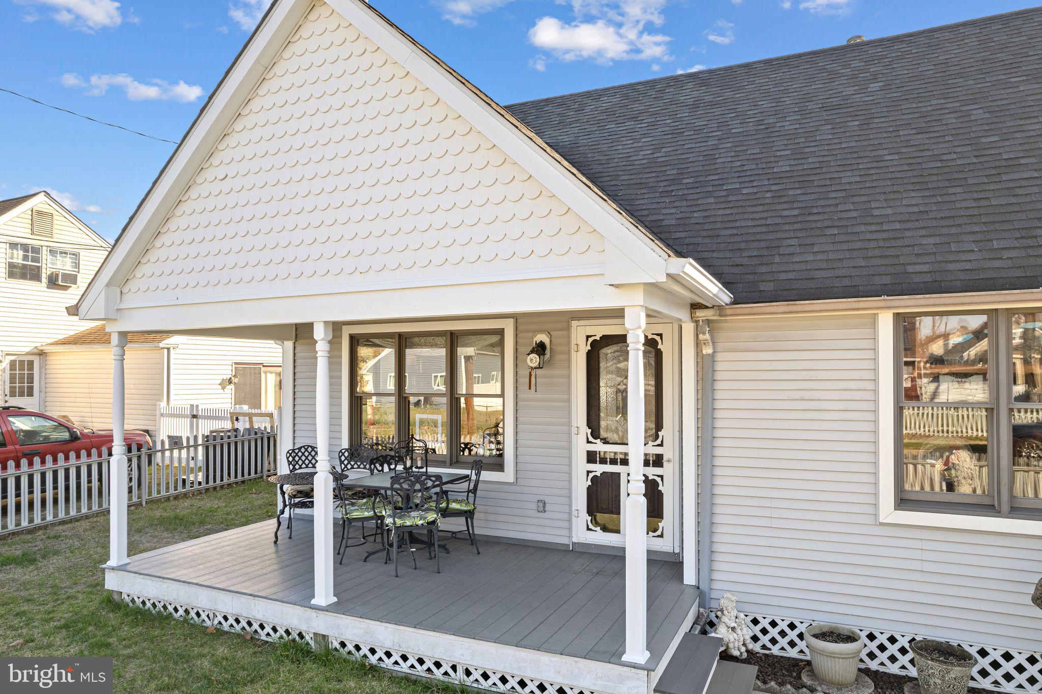 91 Estates Road Pine Hill, NJ 08021 - Photo 5 of 34 a view of a patio with table and chairs and floor to ceiling window