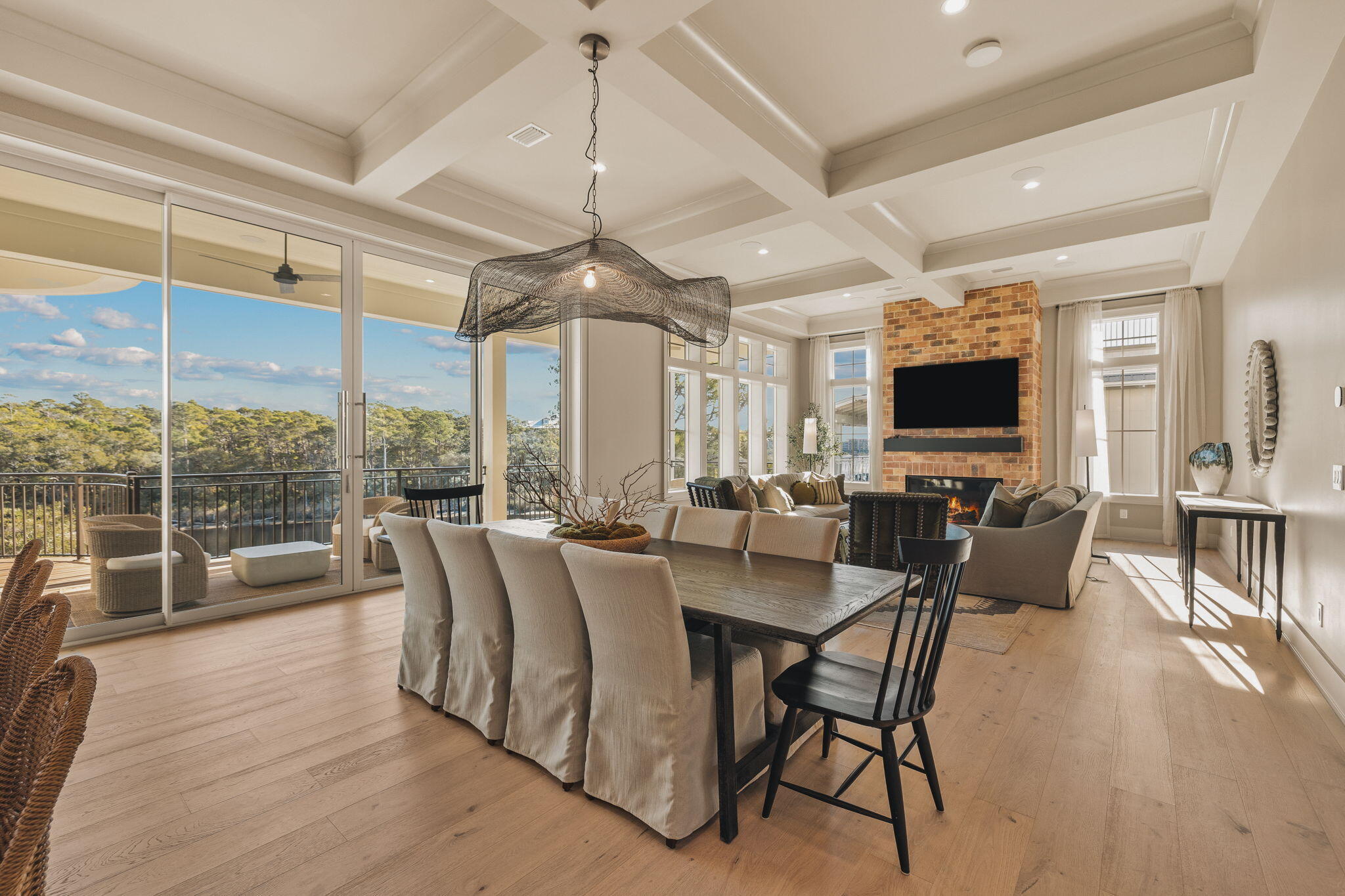 157 Blue Lake Road Santa Rosa Beach, FL 32459 - Photo 22 of 83 a dining room with furniture a chandelier and wooden floor