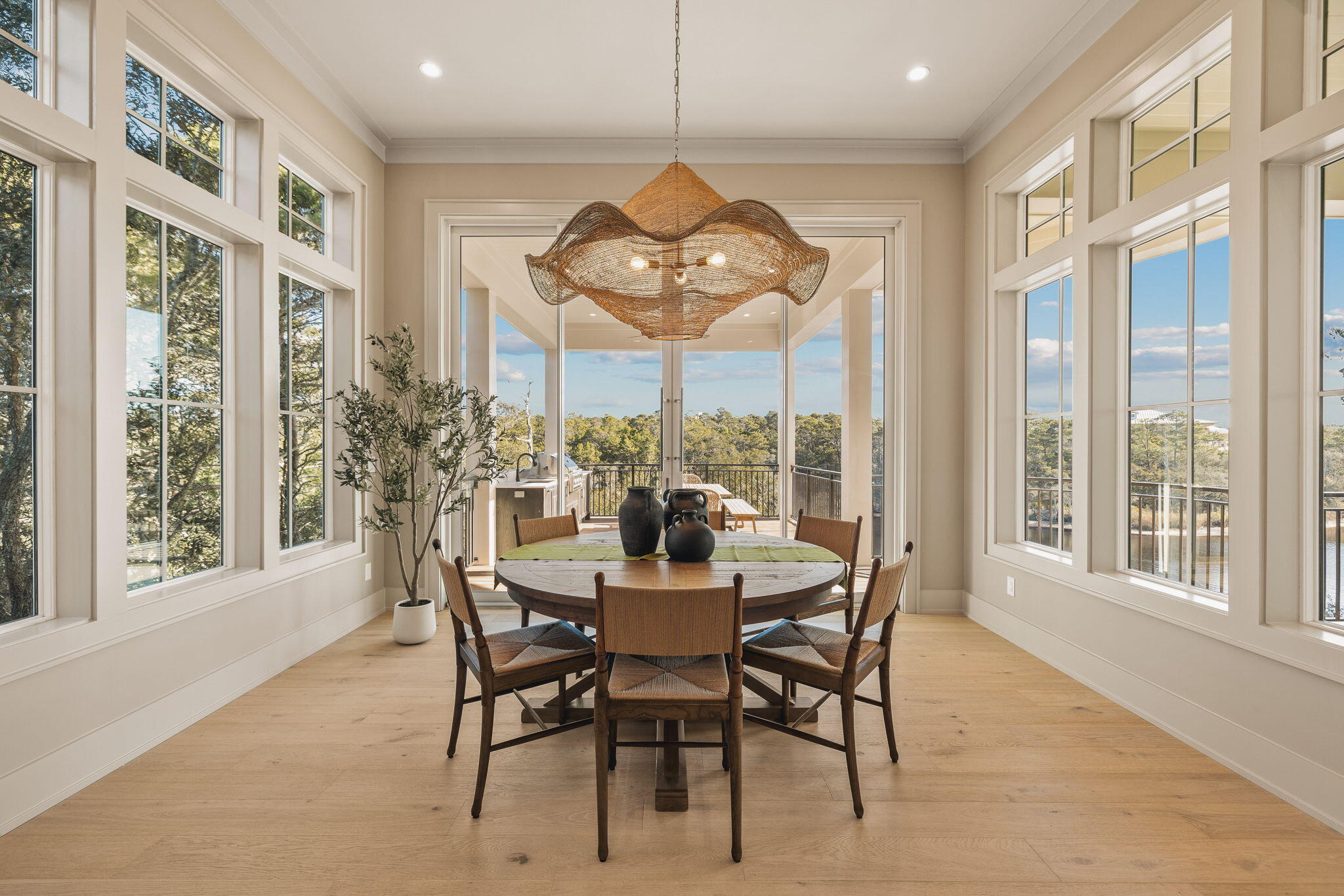 157 Blue Lake Road Santa Rosa Beach, FL 32459 - Photo 32 of 83 a dining room with furniture large windows and a chandelier