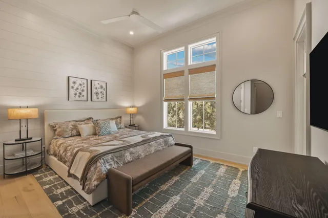 a large bedroom with a large bed couch and windows