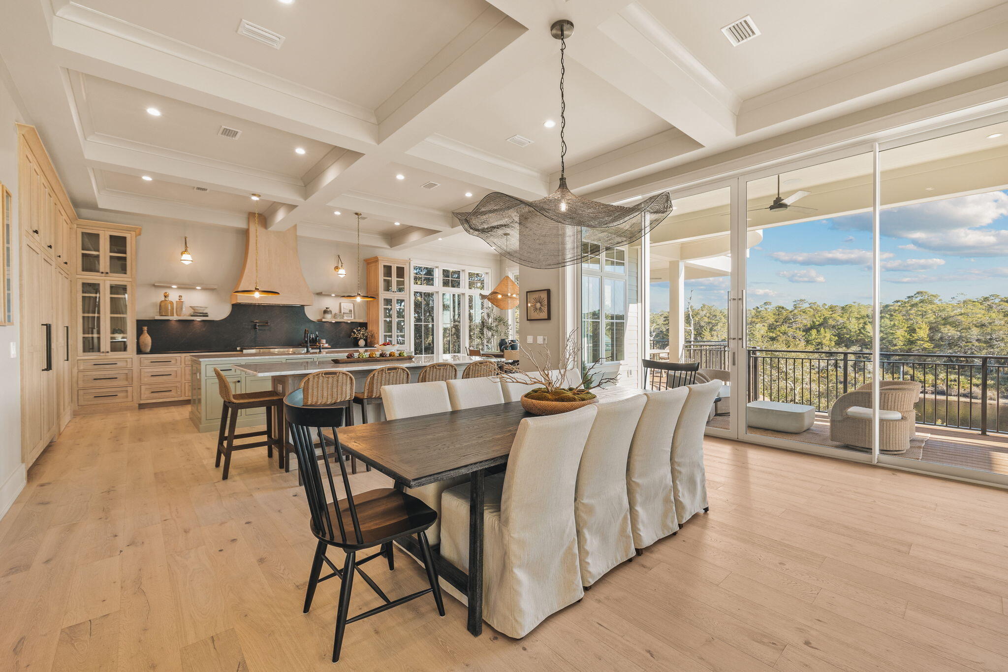 157 Blue Lake Road Santa Rosa Beach, FL 32459 - Photo 6 of 83 a view of a dining room and livingroom with furniture wooden floor a chandelier