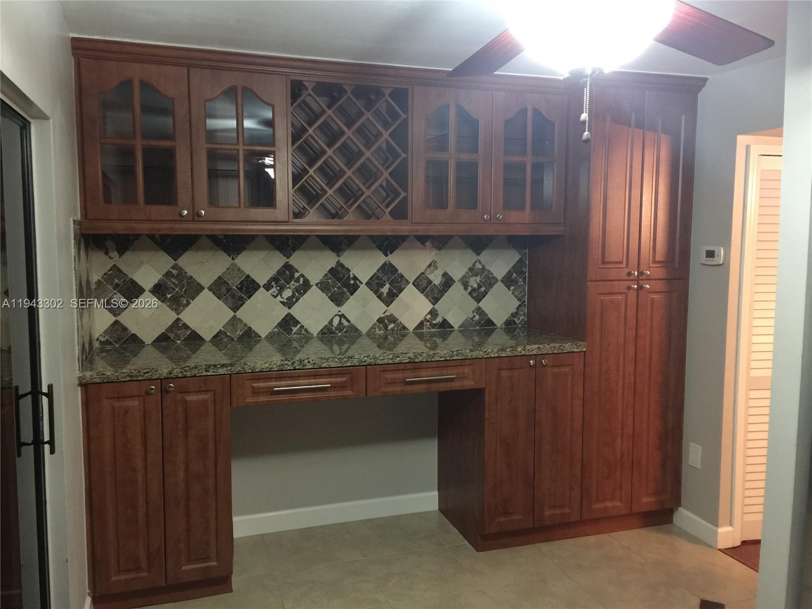 10033 Southwest 77th Court, Unit 10033 Miami, FL 33156 - Photo 2 of 10 a view of wooden cabinets