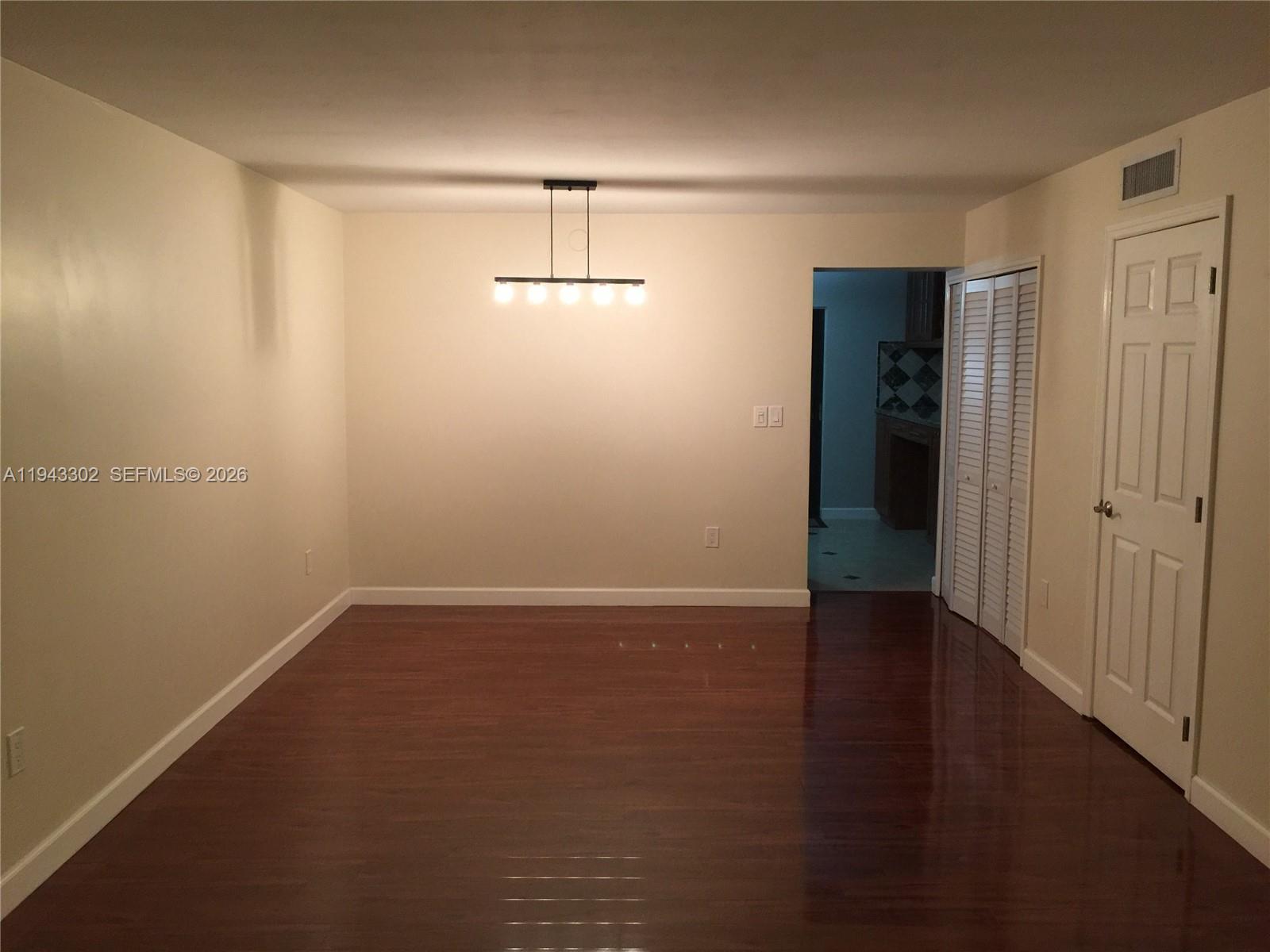 10033 Southwest 77th Court, Unit 10033 Miami, FL 33156 - Photo 3 of 10 wooden floor in an empty room