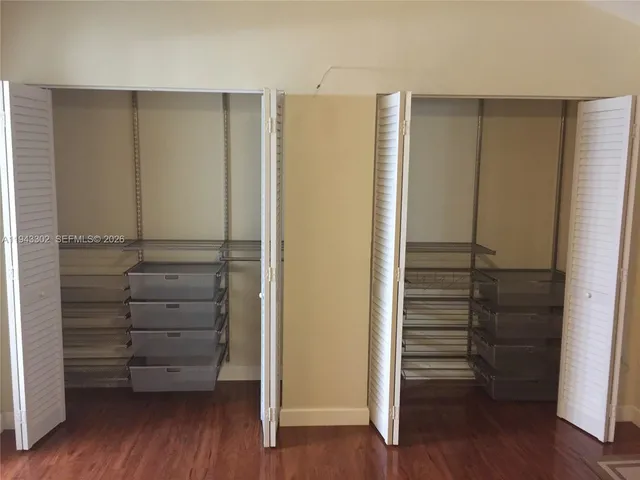 a view of walk in closet with empty racks