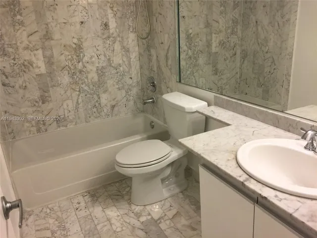a bathroom with a toilet a sink and a bathtub