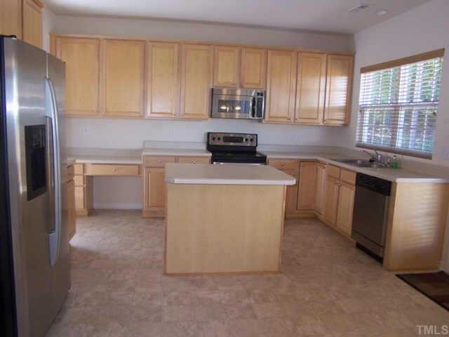 1633 October Road Raleigh, NC 27614 - Photo 5 of 10 a kitchen with granite countertop a sink stove and refrigerator