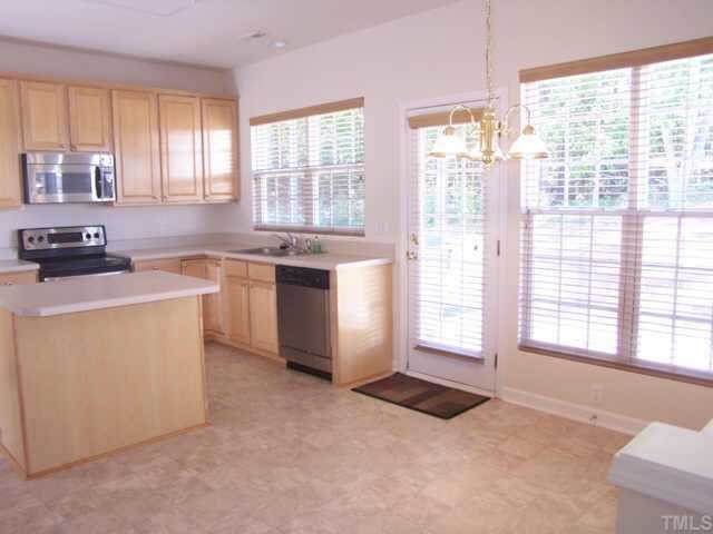1633 October Road Raleigh, NC 27614 - Photo 6 of 10 a kitchen with stainless steel appliances granite countertop a stove a sink and a refrigerator