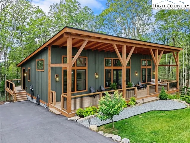 a view of a chair and table in backyard of the house