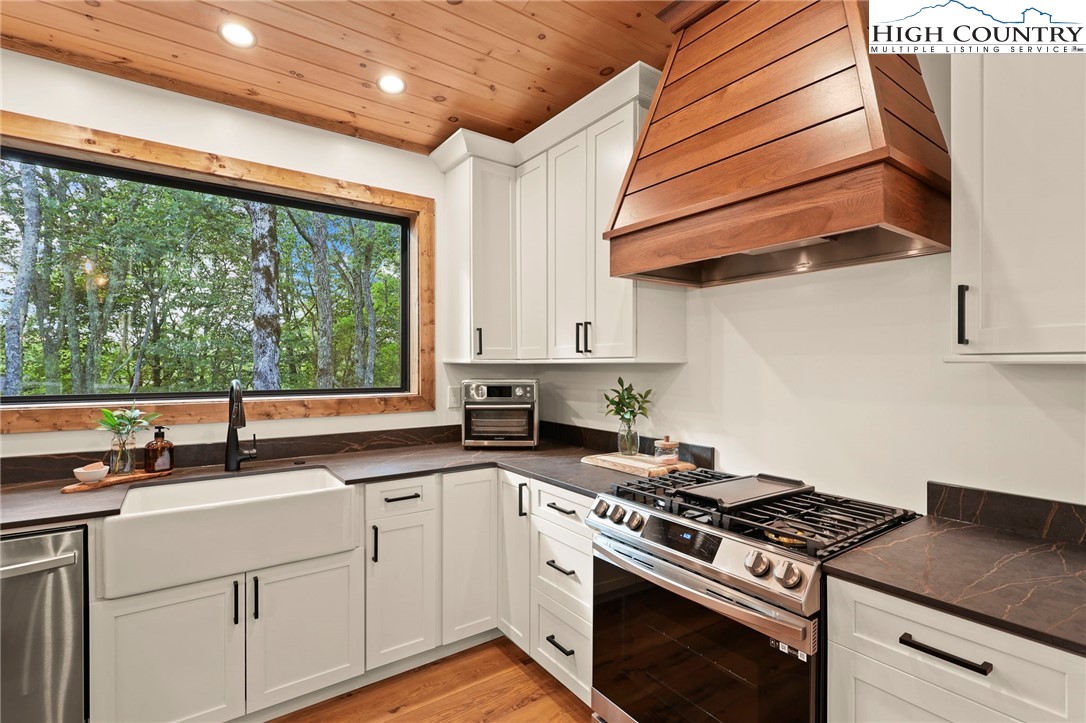 10 Maple Lane Newland, NC 28657 - Photo 12 of 22 a kitchen with stainless steel appliances wooden cabinets and a stove top oven