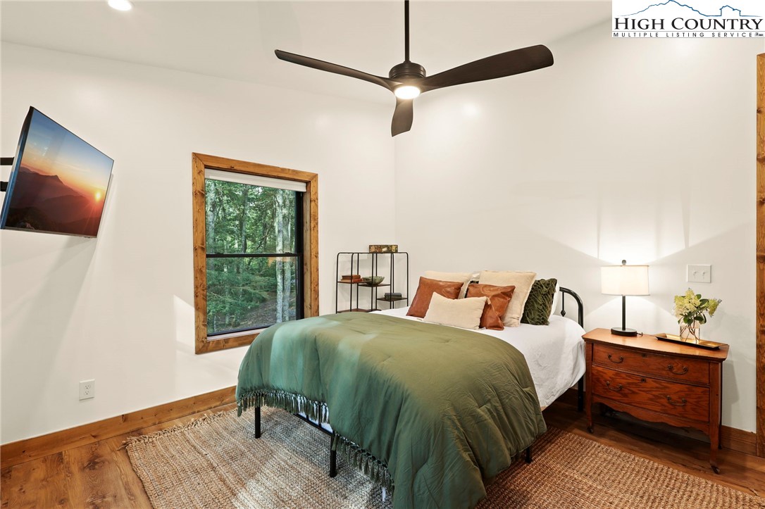 10 Maple Lane Newland, NC 28657 - Photo 17 of 22 a bedroom with a bed a window and a chandelier