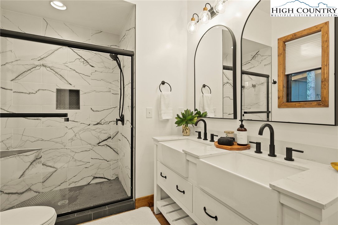 10 Maple Lane Newland, NC 28657 - Photo 19 of 22 a bathroom with a sink a toilet and shower