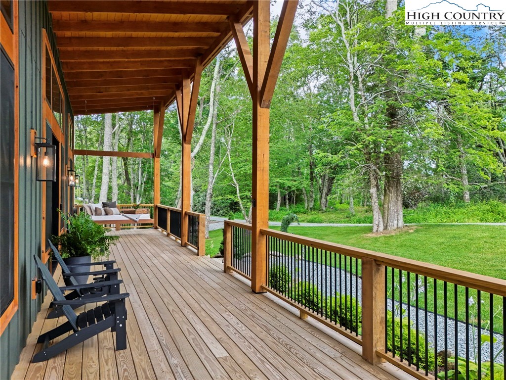10 Maple Lane Newland, NC 28657 - Photo 5 of 22 a view of a patio with lawn chairs floor to ceiling window and a yard