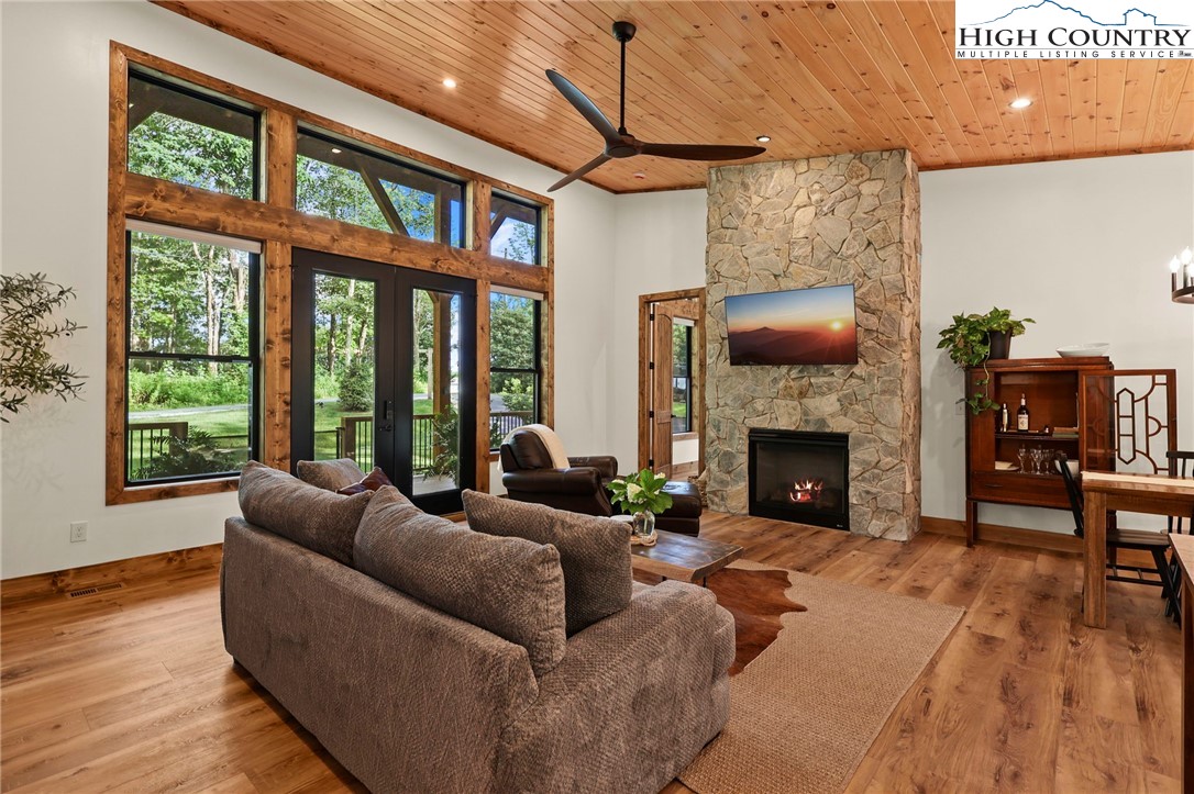 10 Maple Lane Newland, NC 28657 - Photo 9 of 22 a living room with furniture a fireplace and a floor to ceiling window