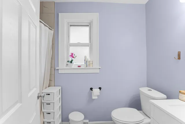 a white toilet sitting next to a bathroom sink