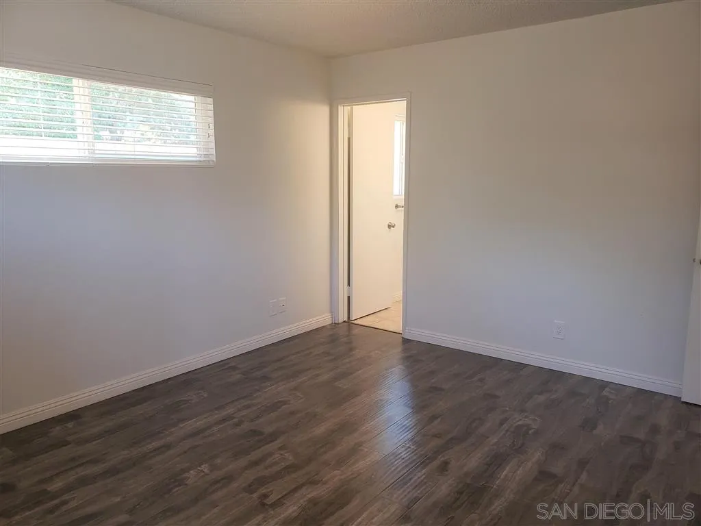 1228 Eucalyptus Avenue Vista, CA 92084 - Photo 11 of 15 an empty room with wooden floor and window