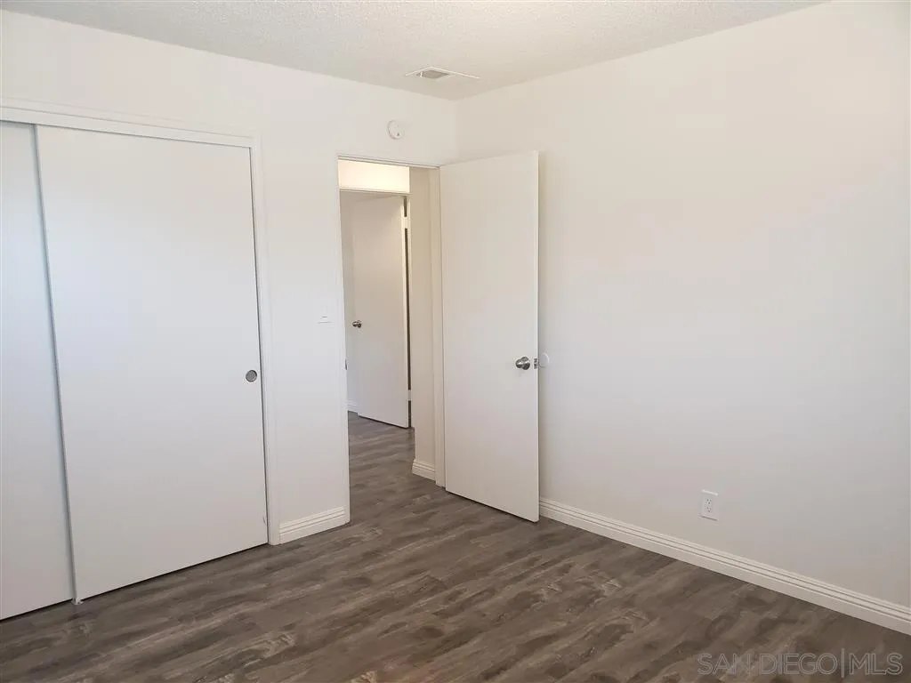 1228 Eucalyptus Avenue Vista, CA 92084 - Photo 14 of 15 a view of an empty room with wooden floor