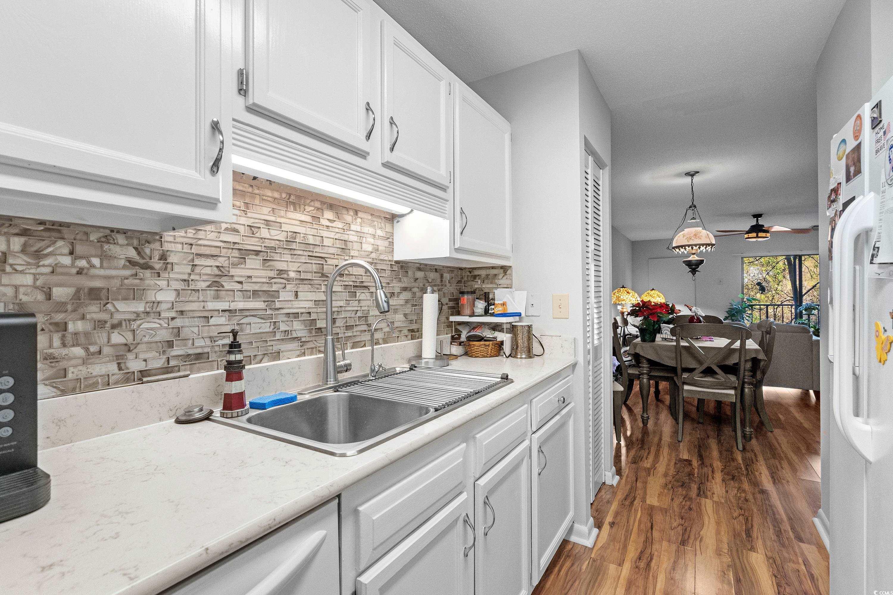 5001 Little River Road, Unit E219 Myrtle Beach, SC 29577 - Photo 13 of 34 Kitchen with backsplash, ceiling fan, sink, pendan