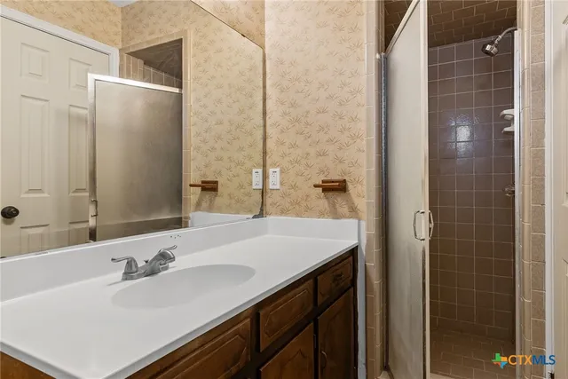 a bathroom with a sink and a mirror