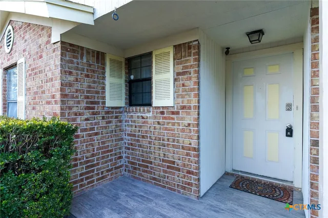 a view of front door of house and wooden floor
