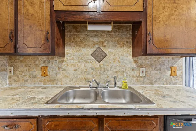 a kitchen sink with granite countertop a sink