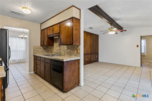 a spacious bathroom with a granite countertop sink a mirror and a shower