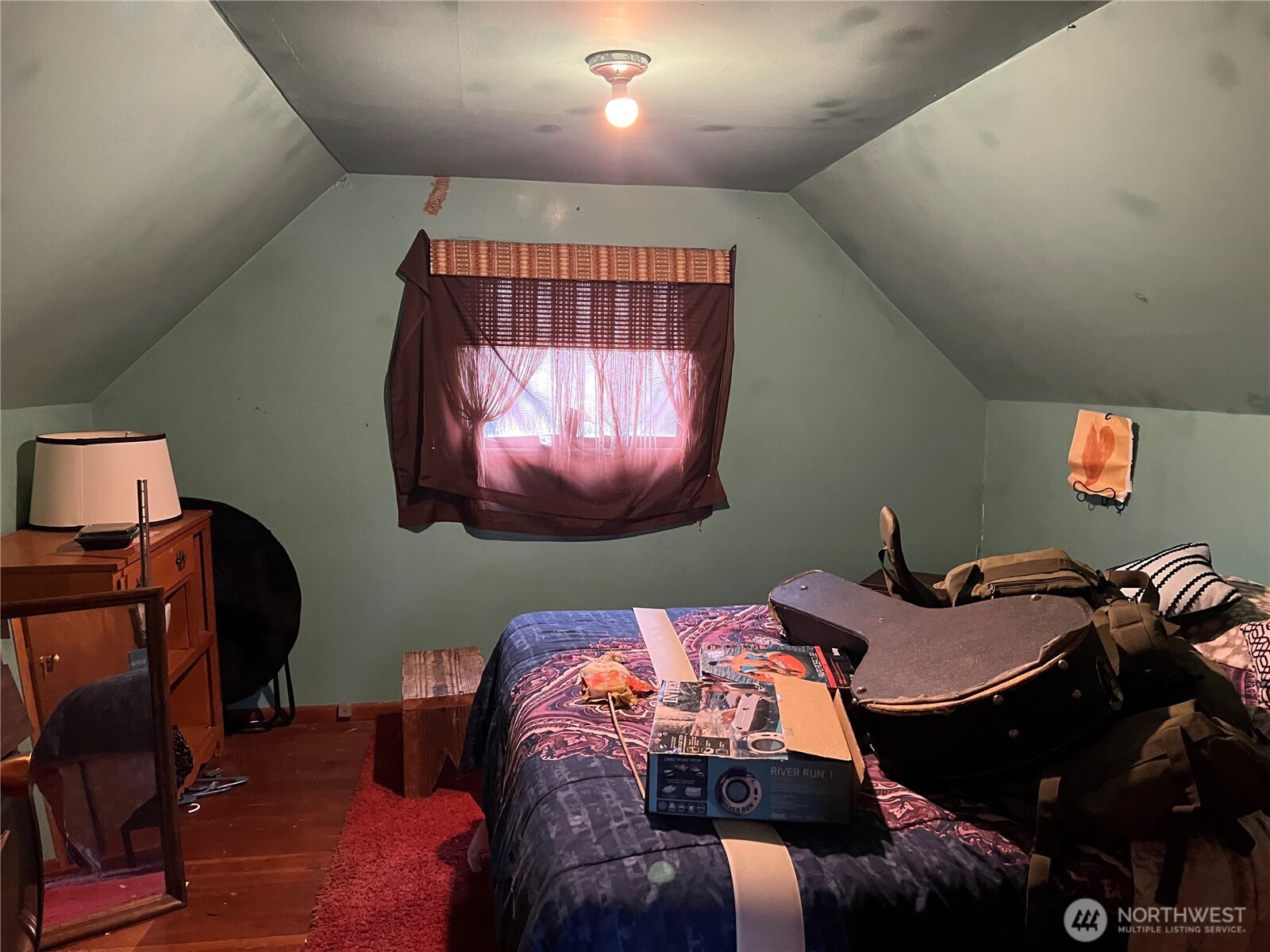 1865 Southwest Fair Avenue Chehalis, WA 98532 - Photo 12 of 15 a bed sitting in a room next to a lamp