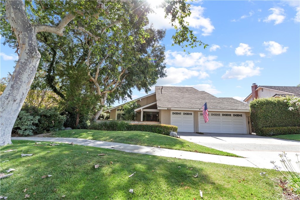 a front view of house with yard and green space
