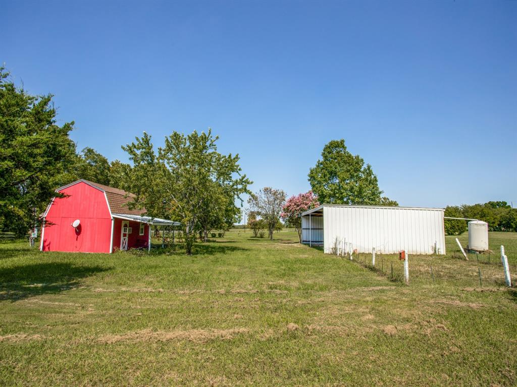 290 East Forest Grove Road Lucas, TX 75002 - Photo 6 of 8 a view of a house with a yard and a garage